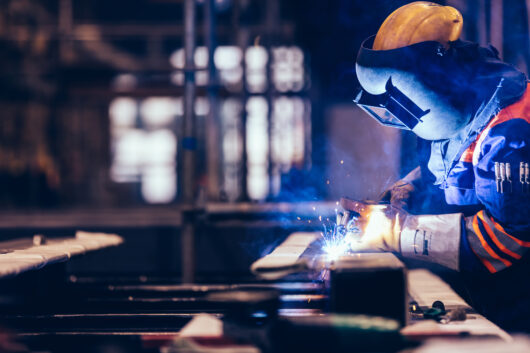 Worker welding in a factory.